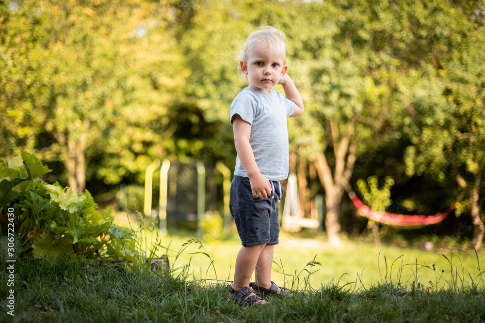 Portrait of little boy during playing in backyard