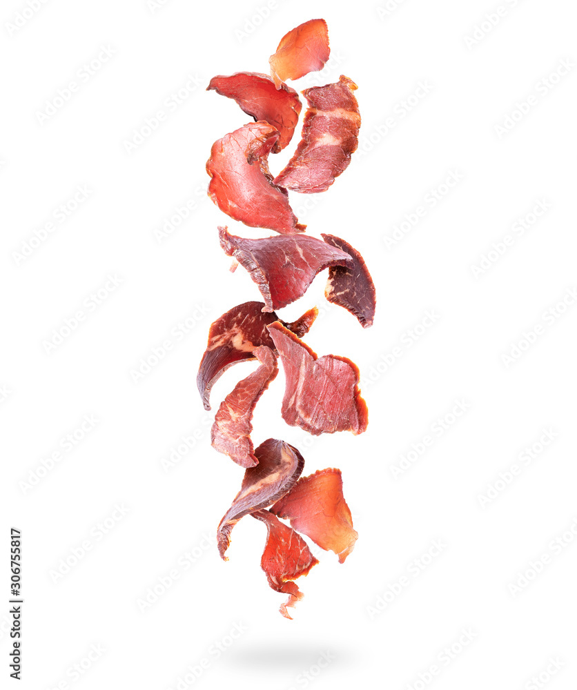 Beef jerky pieces fall down on a white background