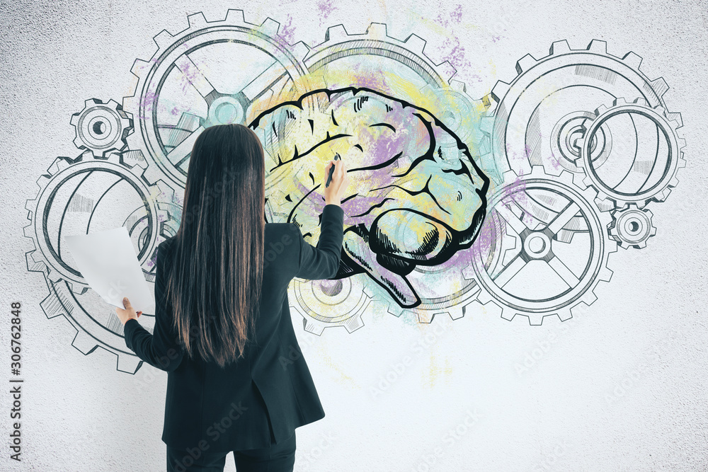 Businesswoman drawing cogs and brain sketch