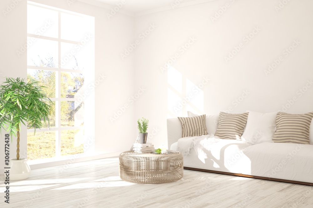 Stylish room in white color with sofa and summer landscape in window. Scandinavian interior design. 