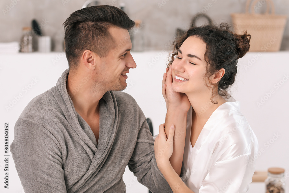 Happy young couple in bathroom at home