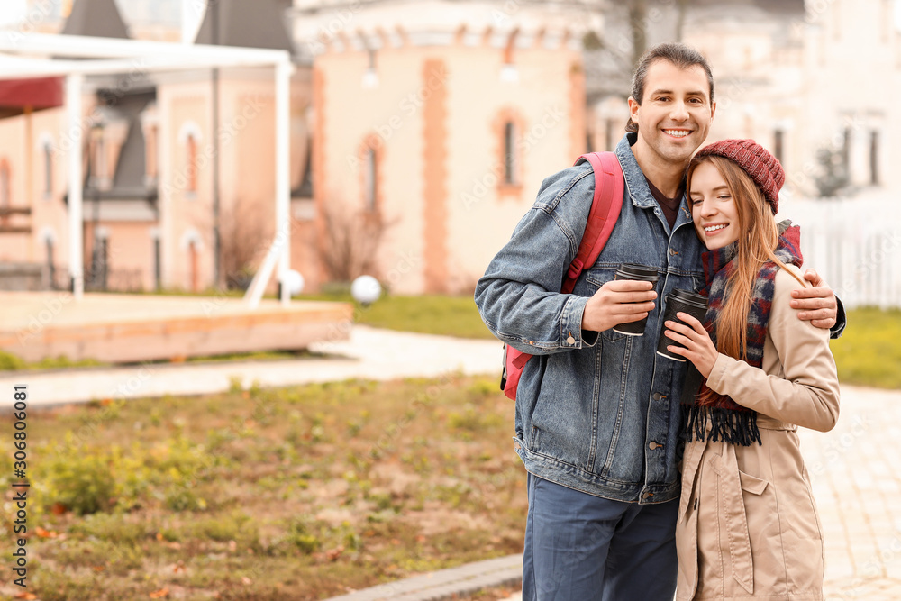 Happy couple walking in autumn city