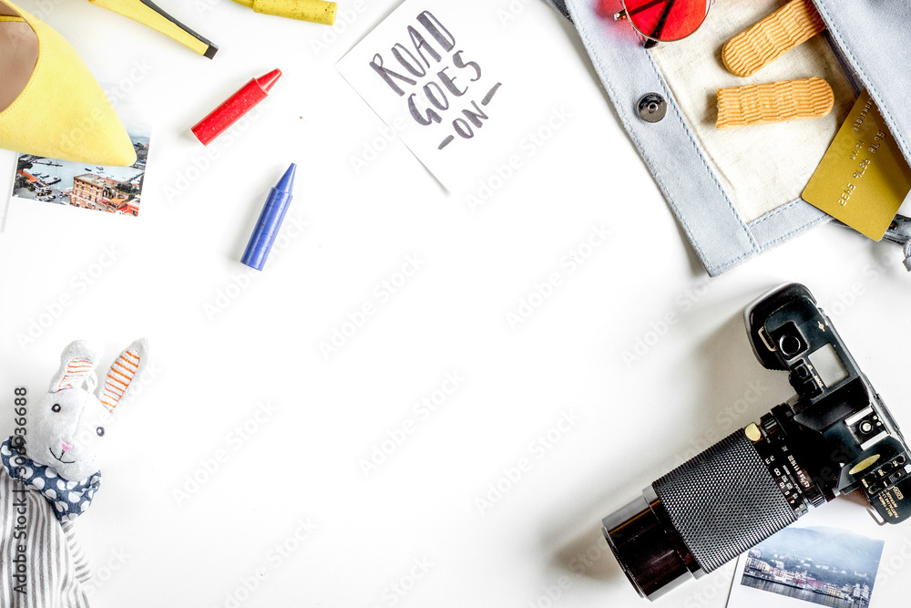 accessories for treveling with children, camera and toys on white background top view mock-up