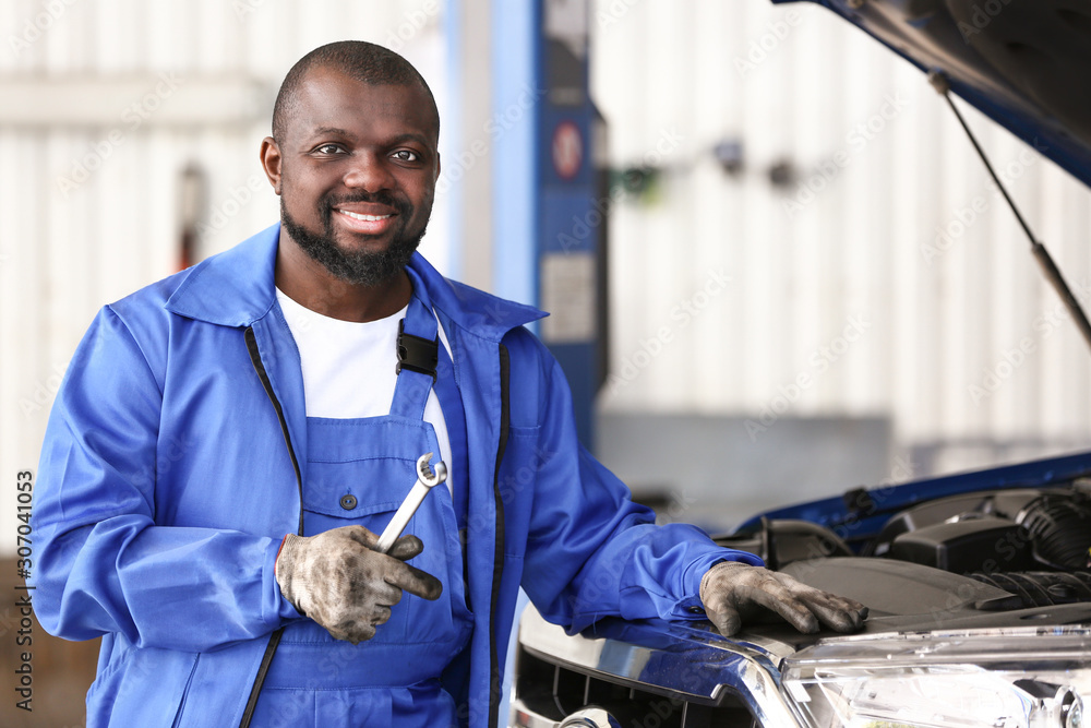 African-American mechanic working in car service center