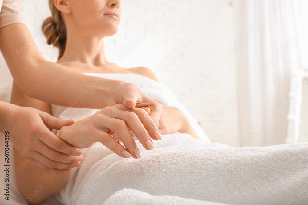 Beautiful woman receiving massage in spa salon