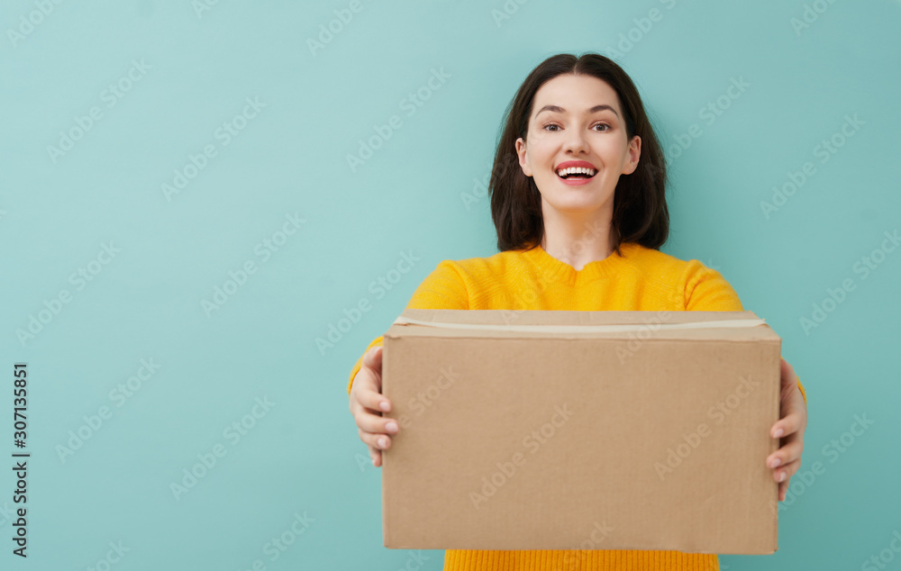 woman is holding cardboard box