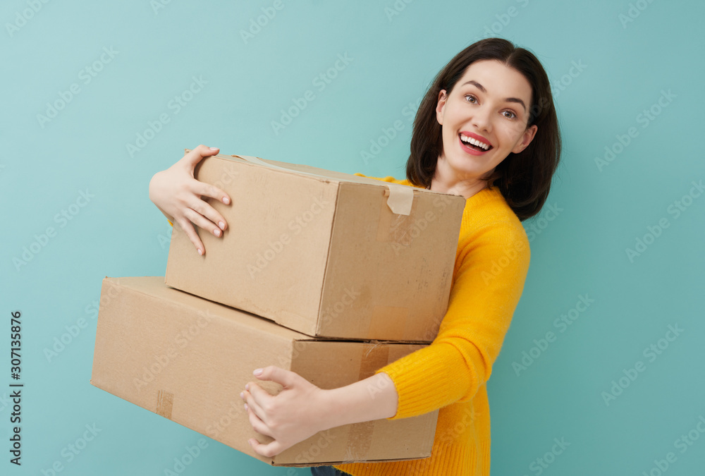 woman is holding cardboard box