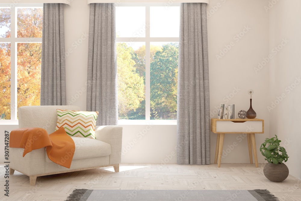 White stylish minimalist room with armchair and autumn landscape in window. Scandinavian interior de