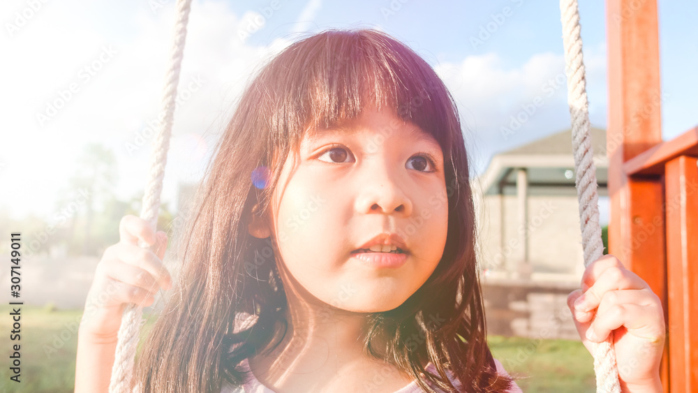 5 years old.Asian child girl playing on playground in outdoor park.Happy Little asian girl playing s