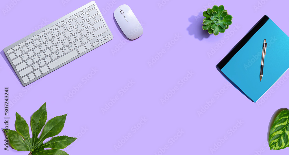 Computer keyboard and mouse with notebook from above