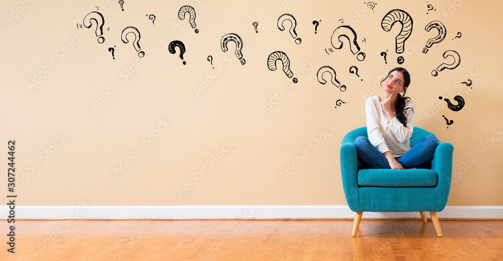 Question marks with woman in a thoughtful pose in a chair