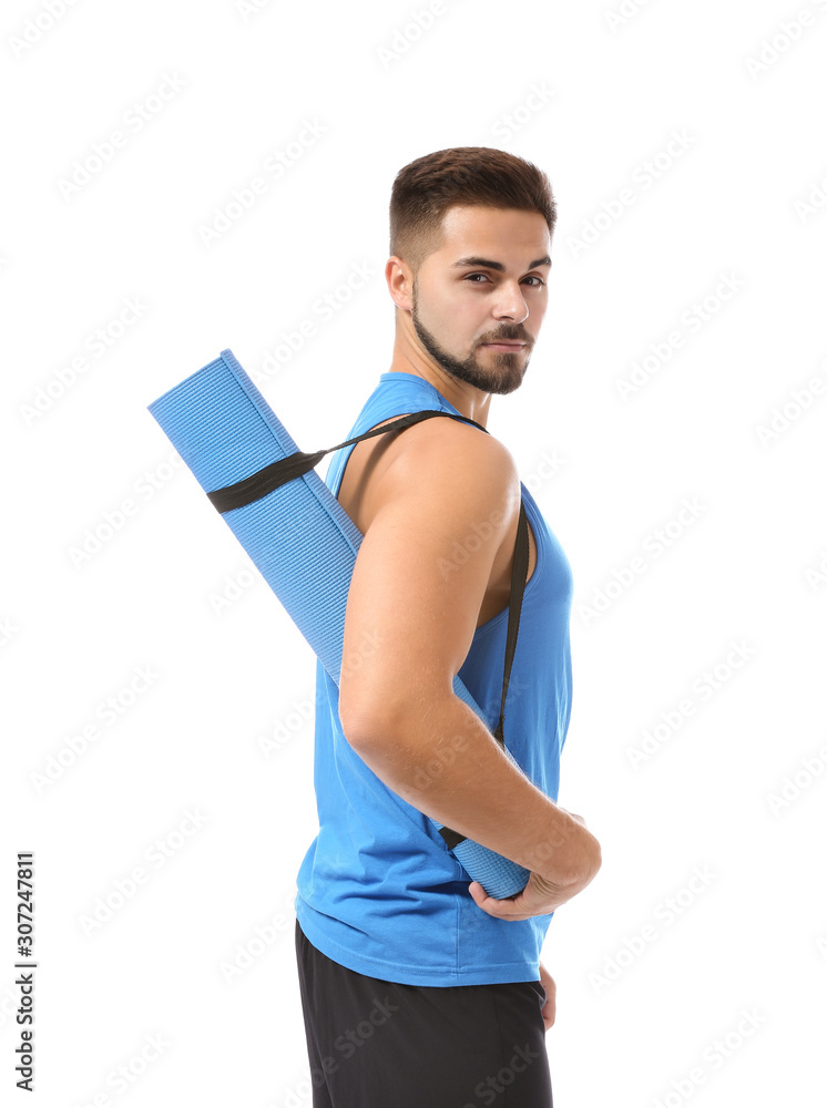 Sporty young man with yoga mat on white background