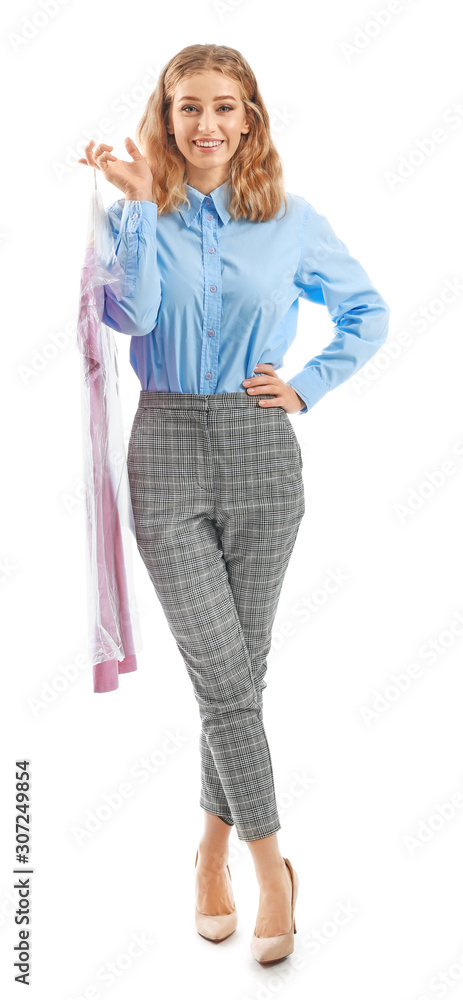 Female worker of modern dry-cleaner with clothes on white background