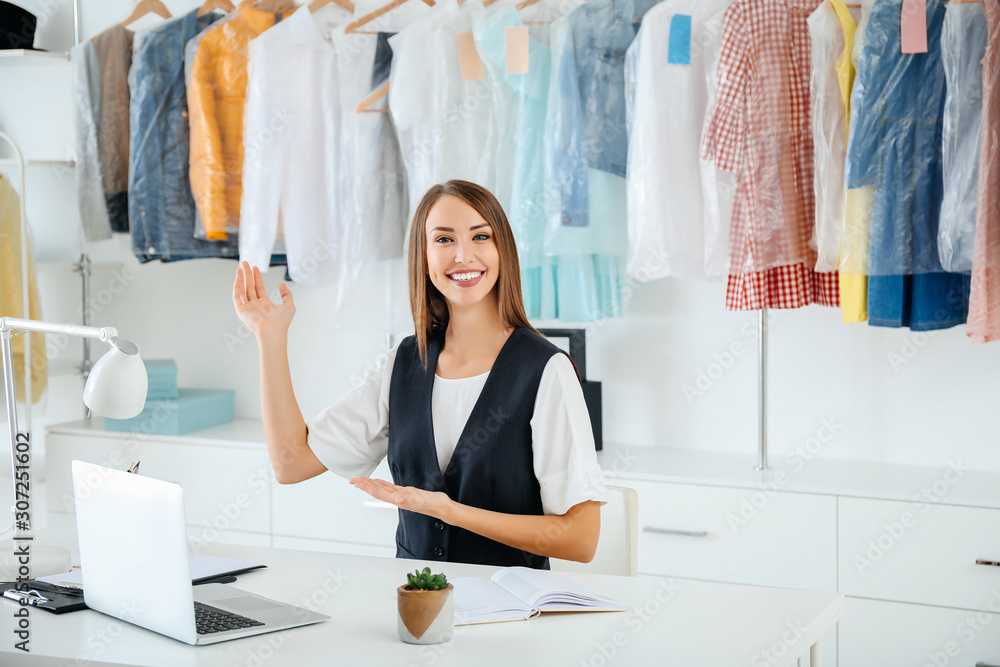 Female worker of modern dry-cleaners at reception