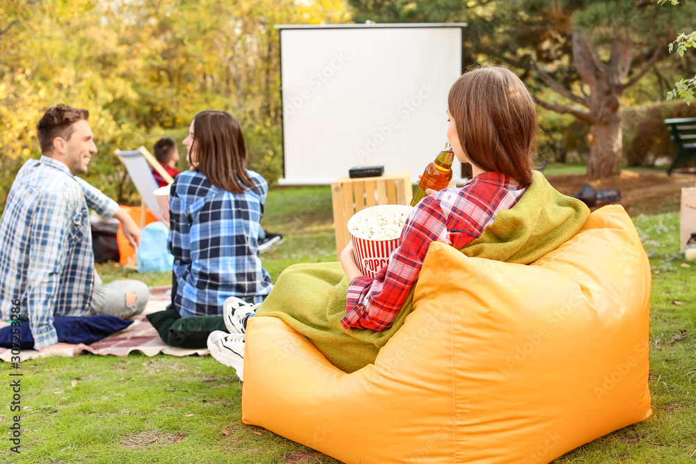 Friends watching movie in outdoor cinema