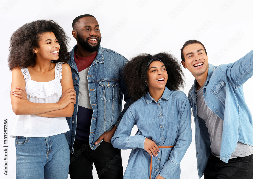 Portrait of young African-American people taking selfie on white background