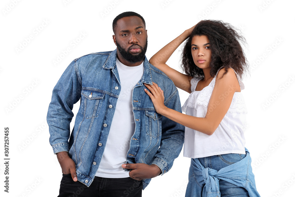 Portrait of stylish young African-American couple on white background