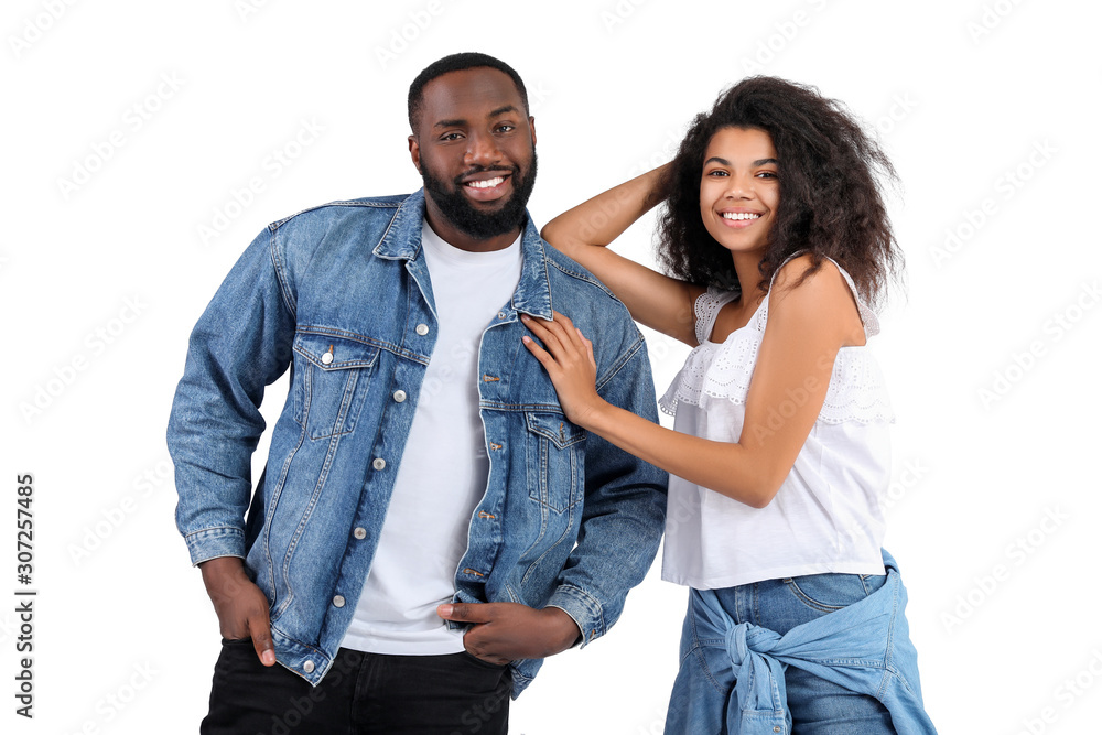 Portrait of stylish young African-American couple on white background