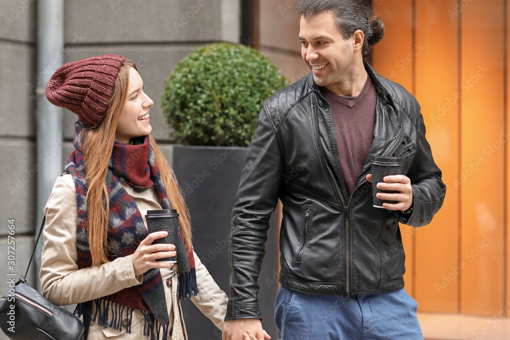 Happy couple walking in autumn city