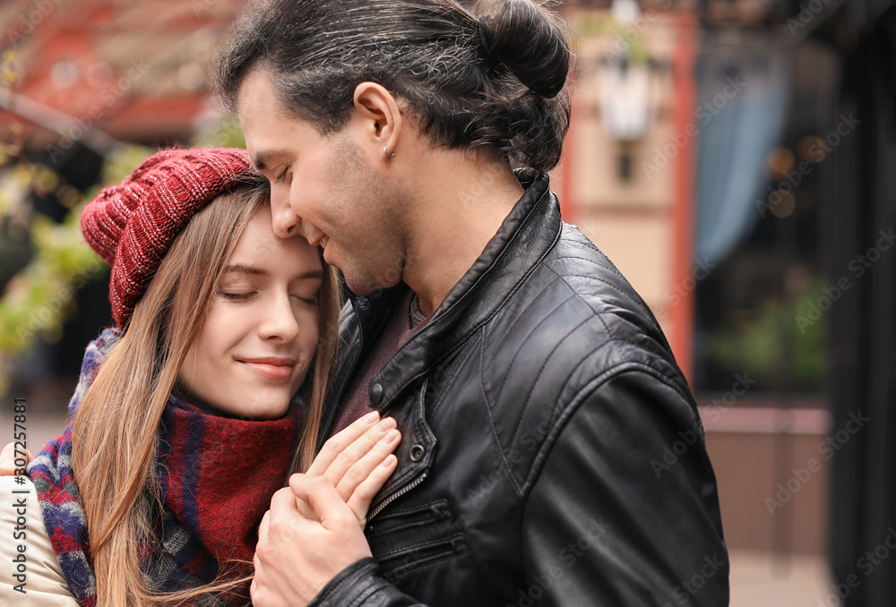 Happy couple walking in autumn city