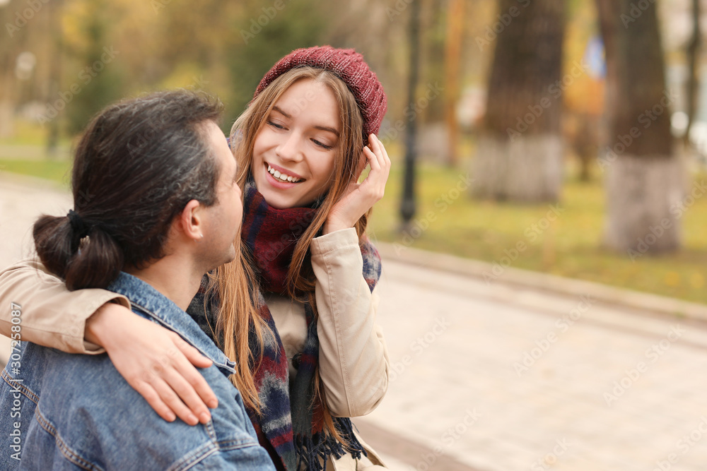 Happy couple resting in autumn park