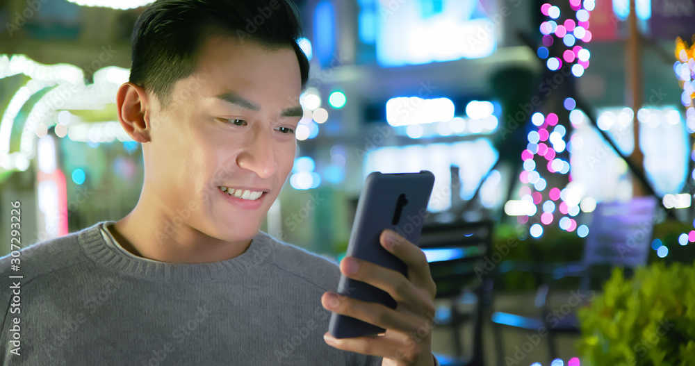 asian man use phone outdoor