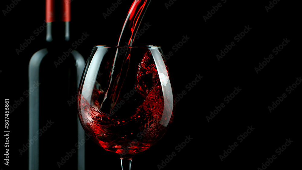 Detail of pouring red wine into glass