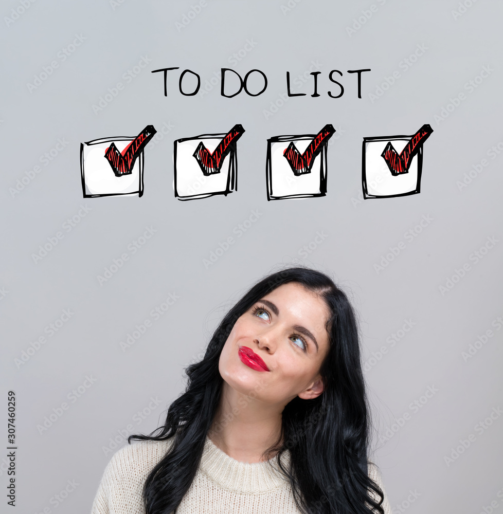 To do list with happy young woman on a gray background