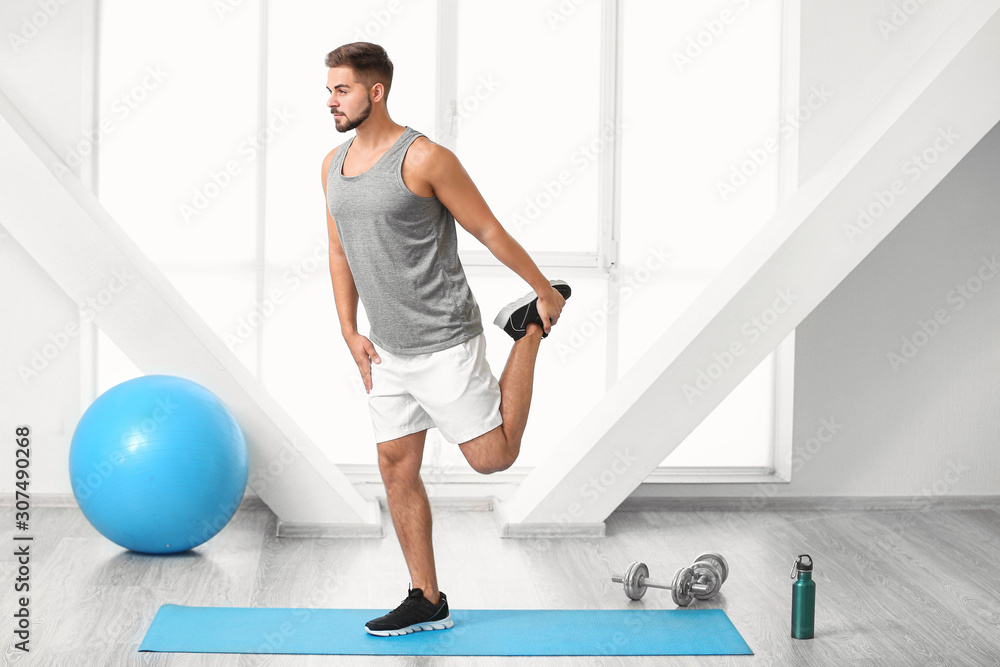 Sporty young man training in gym