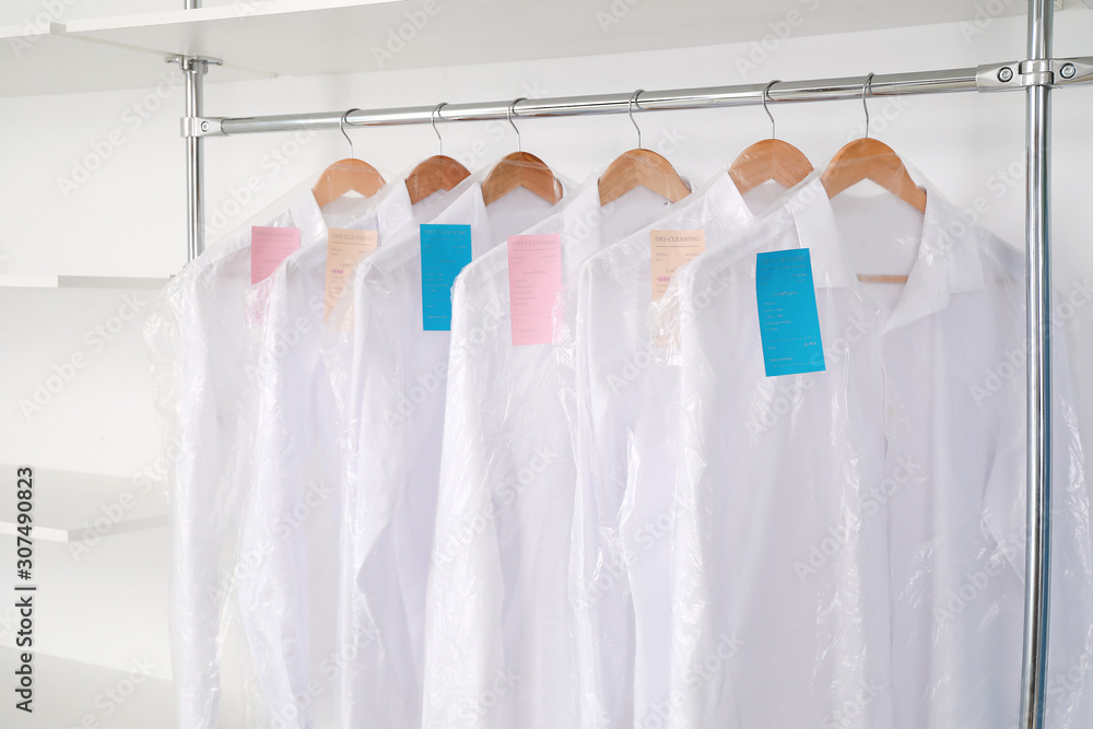 Rack with clothes in modern dry-cleaners