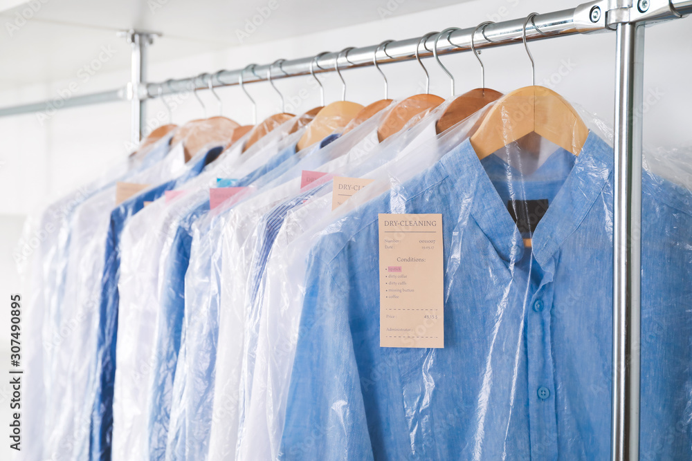 Rack with clothes in modern dry-cleaners