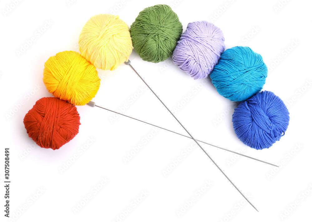 Knitting yarns and needles on white background