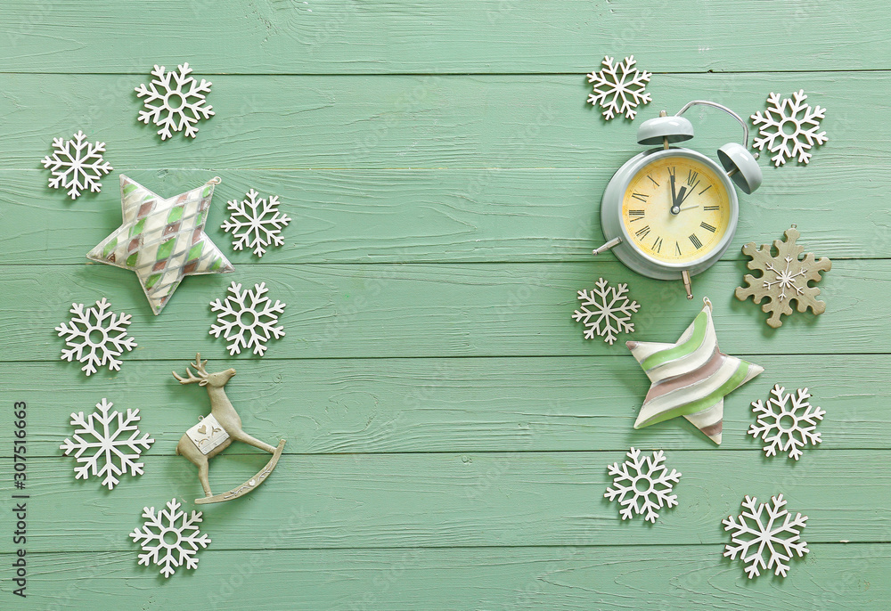 Alarm clock and decor on wooden background. Christmas countdown concept