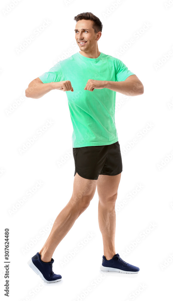 Sporty young man training against white background