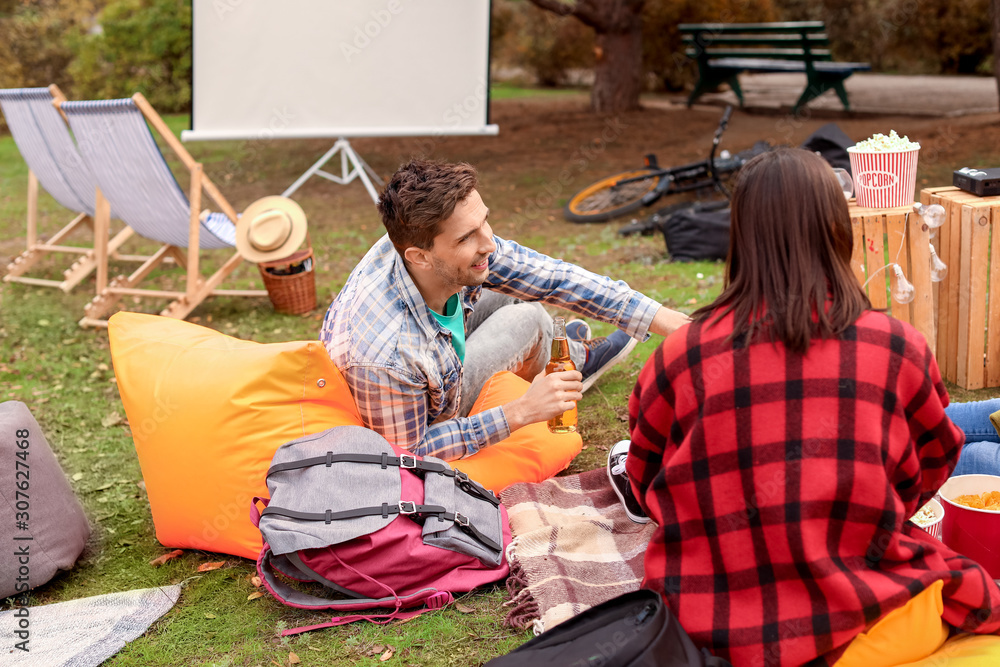 Friends watching movie in outdoor cinema