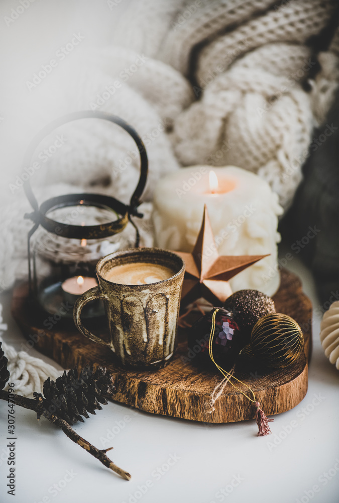 Christmas festive holiday mood composition with coffee in rustic cup, candles and decorative toys, w