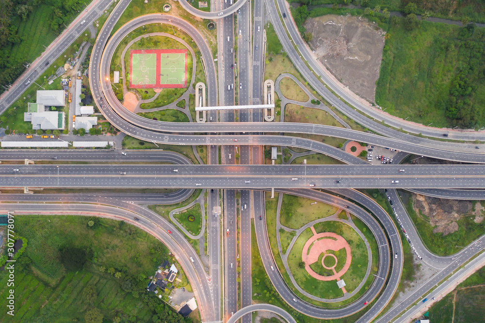 Aerial view of highway junctions Top view of Urban city, Bangkok at evening, Thailand. Car and truck