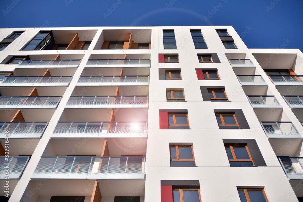 Modern apartment buildings on a sunny day with a blue sky. Facade of a modern apartment building. Gl