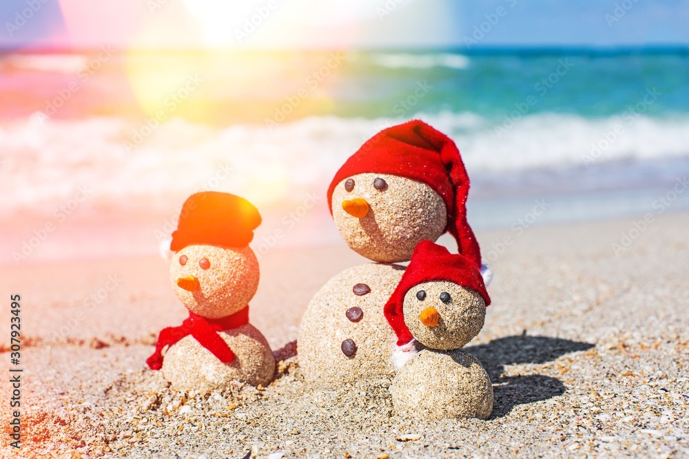 Sandy snowmen. Holiday concept can be used for New Years and Christmas Cards