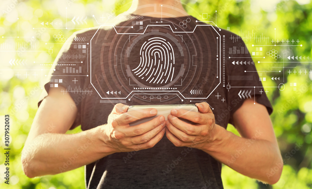 Fingerprint scanning theme with young man holding his smartphone outside