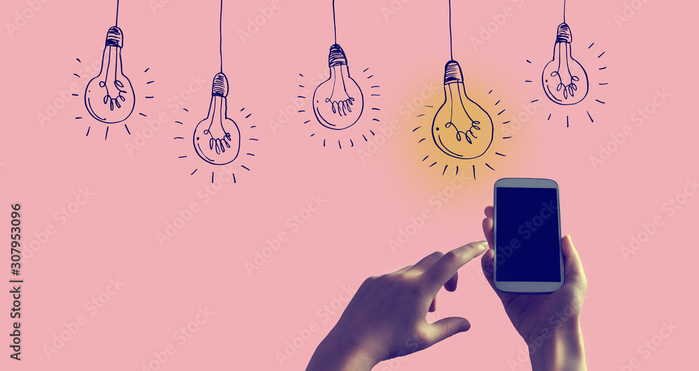 Idea light bulbs with person holding a white smartphone