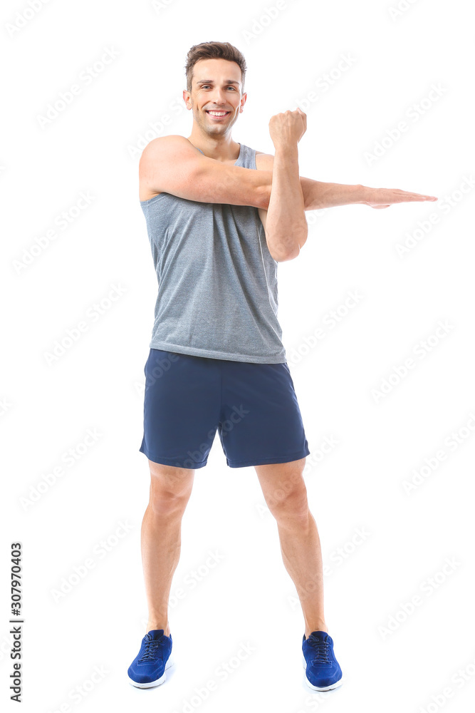 Sporty young man training against white background