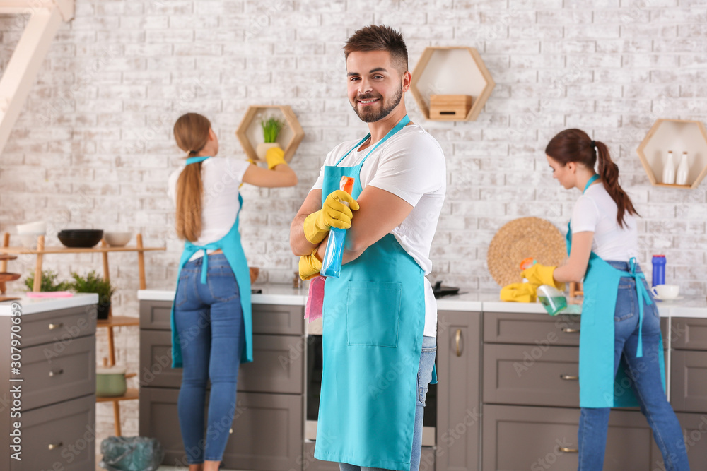 Male janitor with colleagues in kitchen