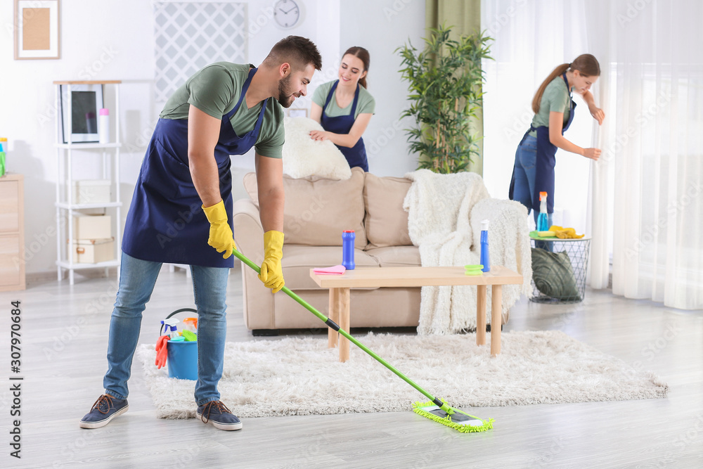 Team of janitors cleaning room