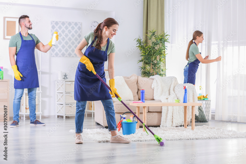 Team of janitors cleaning room