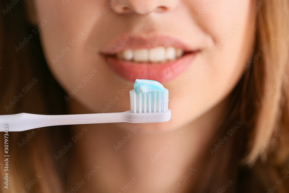 Young woman brushing teeth, closeup