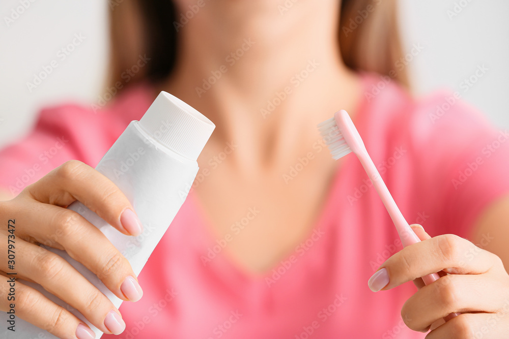 Young woman with tooth brush and paste, closeup