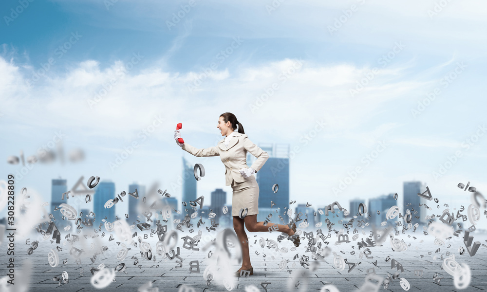 Woman running outdoor with vintage red phone