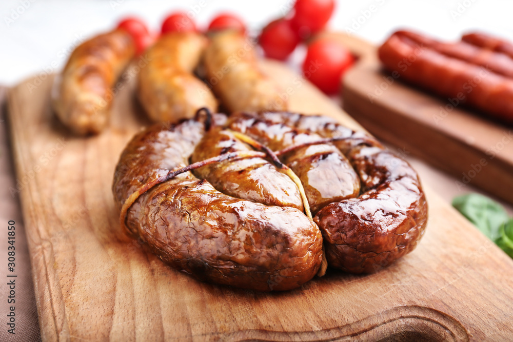 Tasty grilled sausages wooden board, closeup