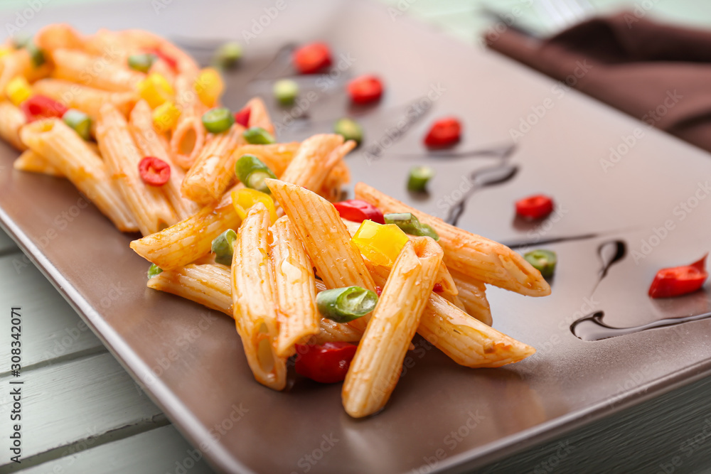 Tasty pasta with tomato sauce on plate, closeup